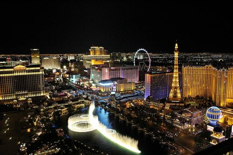 an aerial view of a city at night, a photo, happening, well lit night in las vegas, fountain in the middle, nice weather, in 2 0 1 2