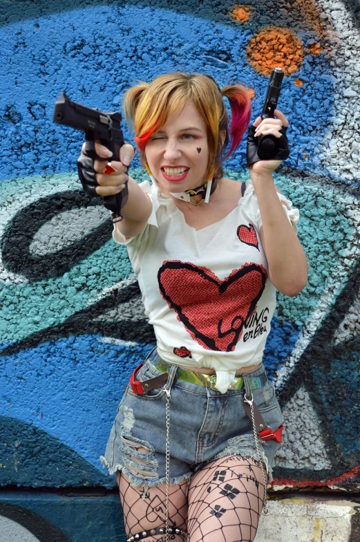 a woman holding two guns in front of a graffiti wall, a portrait, flickr, harley quinn, chucky style, headshot photo, y 2 k cutecore clowncore