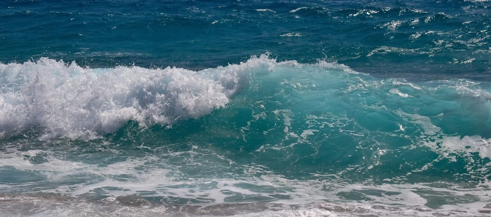 a man riding a wave on top of a surfboard, pexels, fine art, glistening seafoam, mediterranean beach background, aquamarine, ( ( ( kauai ) ) )