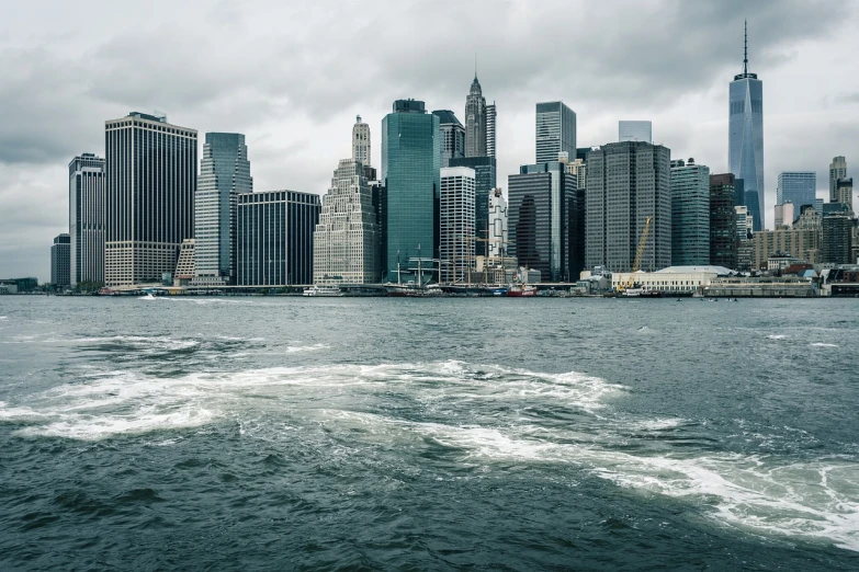 a large body of water with a city in the background, inspired by Thomas Struth, shutterstock, cold stormy wind, street of new york, the photo was taken from a boat, modern high sharpness photo