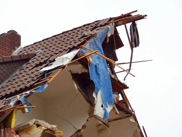 a roof that has been torn off of a house, a photo, by Niko Henrichon, shutterstock, andrzej marszalek, injured, above side view, 3 4 5 3 1