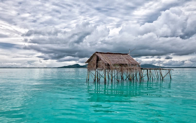 a hut in the middle of a body of water, a stock photo, by Richard Carline, shutterstock, sumatraism, big overcast, turqouise, melting clouds, july 2 0 1 1