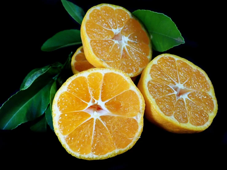 a group of oranges sitting next to each other, a portrait, hurufiyya, on a black background, with lemon skin texture, sasai ukon masanao, platinum