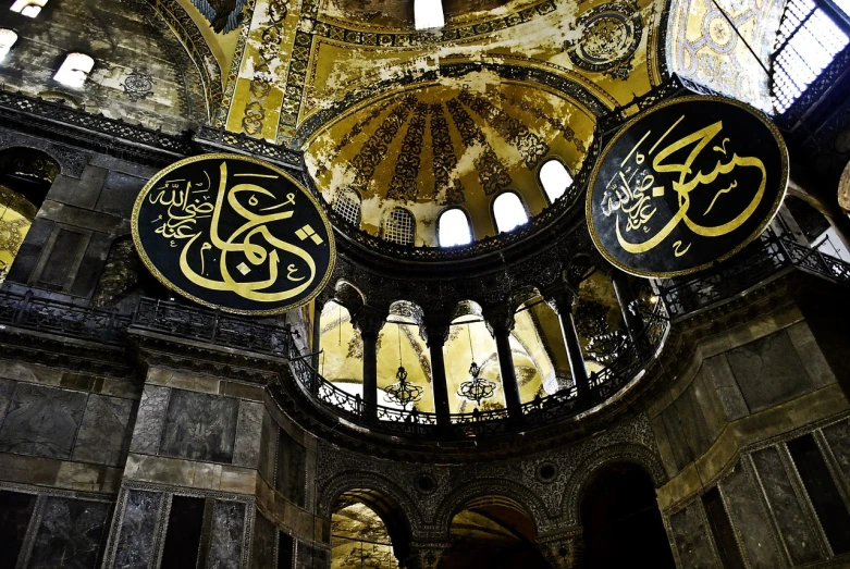 a picture of the inside of a building, a mosaic, featured on pixabay, hurufiyya, black domes and spires, caligraphy, inlaid with gold, circular windows