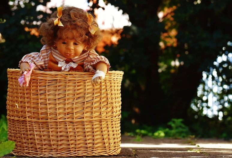 a doll that is sitting in a basket, a picture, pixabay contest winner, realism, soft autumn sunlight, realistic footage, golden hour photo, highly detailed picture