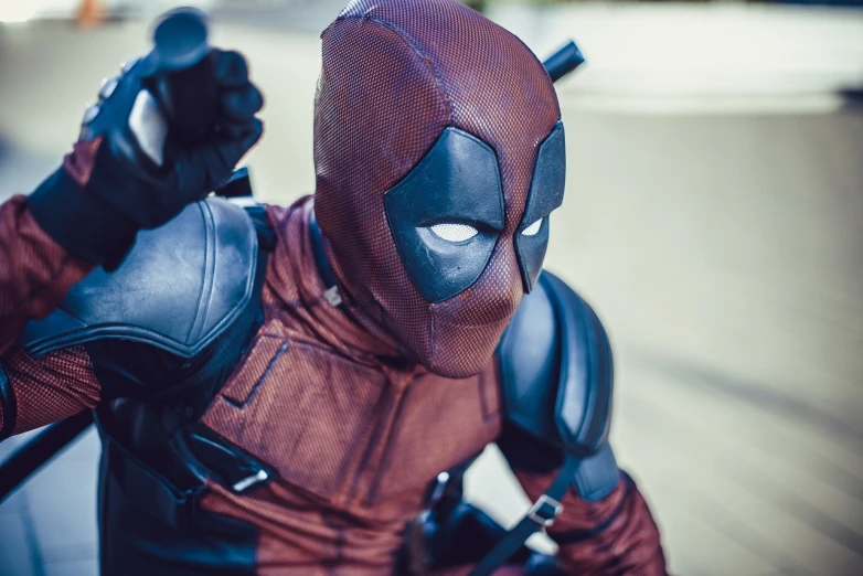 a close up of a person in a deadpool costume, a stock photo, by Alexander Fedosav, post processed 4k, dynamic action shot, looking furious, shot on 70 mm