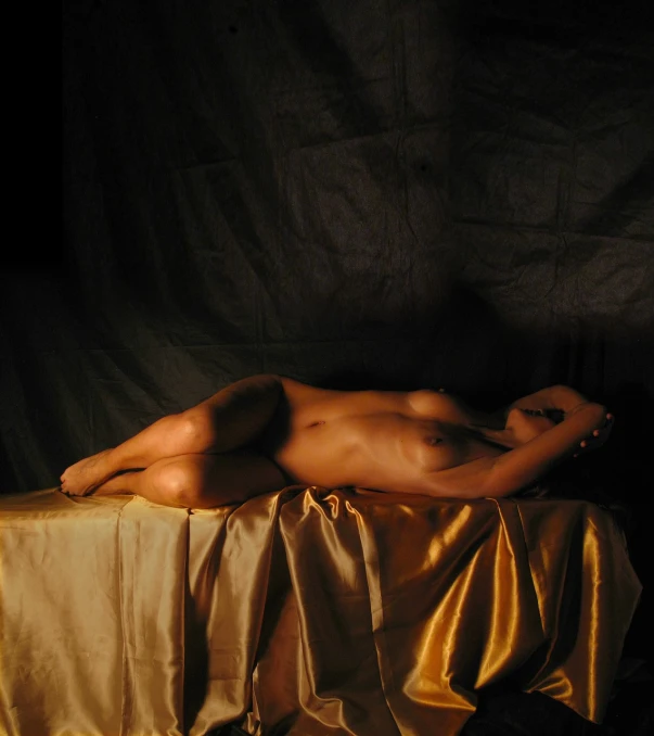 a naked man laying on a gold cloth, inspired by Jean Auguste Dominique Ingres, flickr, sexy girl with dark complexion, full length view, on a table, set photograph