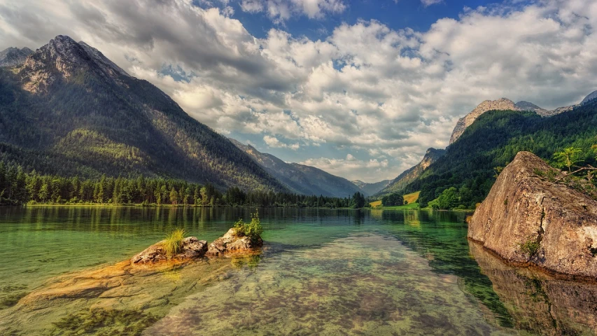 a body of water with mountains in the background, by Karl Walser, pixabay, shallow waters, lush scenic landscape, amazing depth, austria