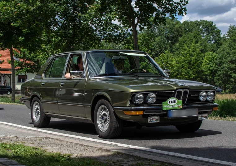 a man sitting in the driver's seat of a green car, by Dietmar Damerau, flickr, renaissance, bmw e 3 0, with big chrome tubes, vintage - w 1 0 2 4, bronze poli