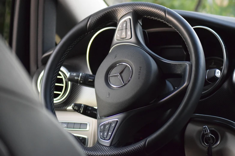 a close up of a steering wheel in a car, mercedez benz, 2 0 % pearlescent detailing, alterd carbon, taken with canon 8 0 d