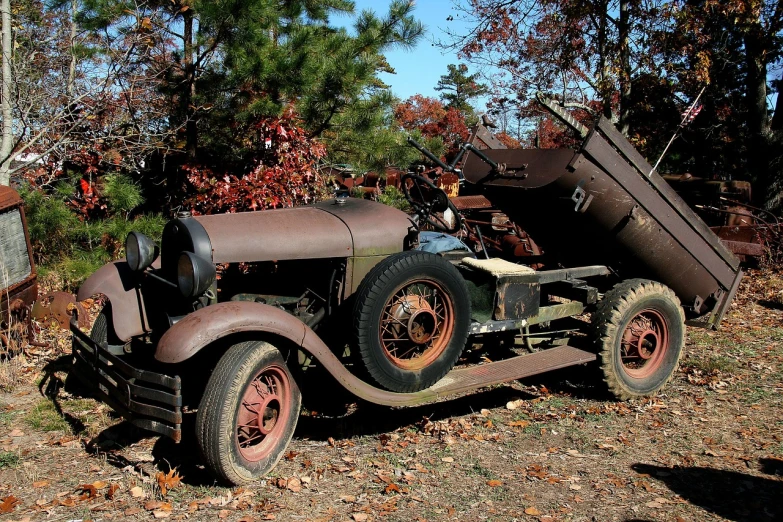 an old car is parked on the side of the road, flickr, folk art, tommy gun, 3/4 front view, disassembled, truck