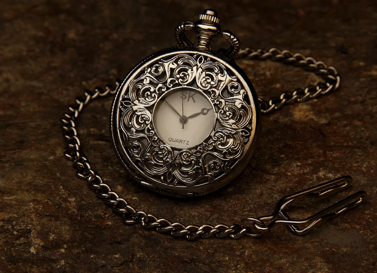 a close up of a pocket watch on a chain, a detailed drawing, by Cindy Wright, pixabay, silver very ornate jewelry, photorealism. trending on flickr, dark!! intricate, morning shot