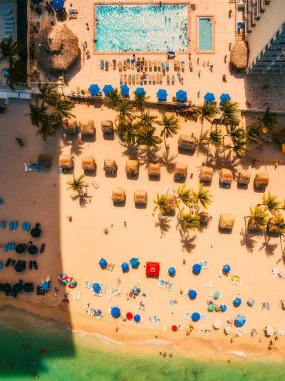an aerial view of a beach with lounge chairs and umbrellas, a tilt shift photo, by Daniel Lieske, pexels contest winner, colombian, coconuts, warm sunshine, sandcastle