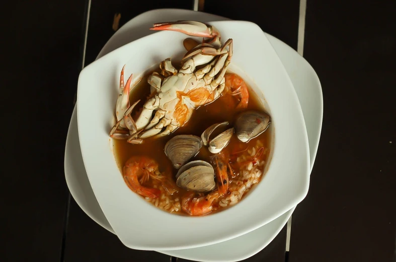 a close up of a bowl of food on a table, by Matteo Pérez, pixabay, crustacean, soup, cut-away, stuffed