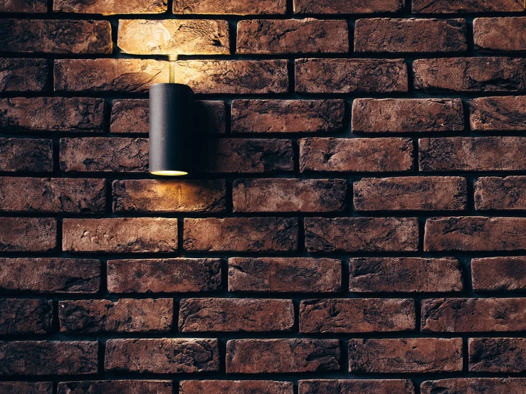 a brick wall with a light on it, by Jens Søndergaard, direct lighting, high quality details, cinematic counter light, stylish lighting