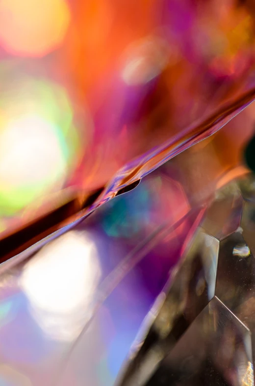 a close up of a diamond on a table, a macro photograph, by Jan Rustem, crystal cubism, layers of colorful reflections, swirly bokeh, colorful plastic, abstract background