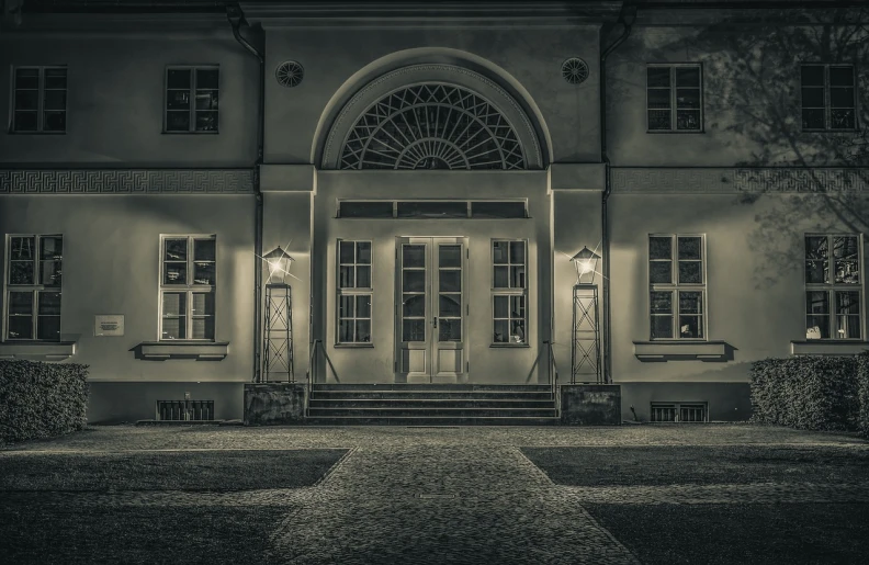 a black and white photo of a building at night, a black and white photo, by Wolfgang Zelmer, cg society contest winner, art nouveau, private academy entrance, desaturated color, private school, 2 4 mm iso 8 0 0