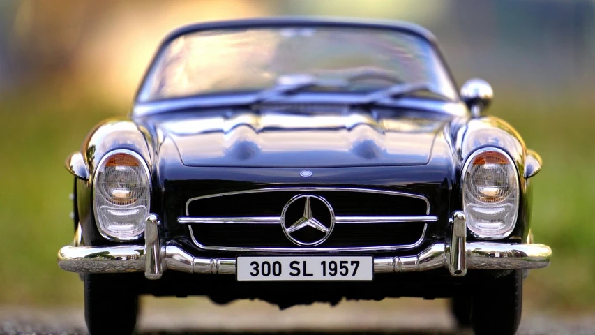 a black mercedes benz benz benz benz benz benz benz benz benz benz benz benz benz benz benz, a tilt shift photo, by Hans Schwarz, trending on pixabay, 1957, closeup portrait, photorealism. trending on flickr, miniature of a sports car