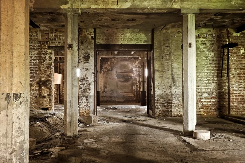 an old building with a door in the middle of it, by Kurt Roesch, flickr, cavernous interior wide shot, rundown buildings, fallen columns, dim lit