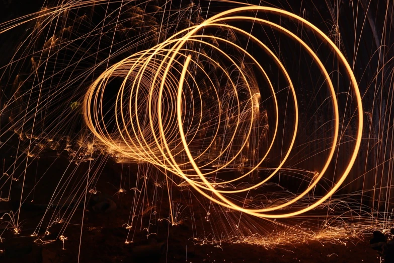a group of people standing around a circle of sparks, a stipple, by Tom Carapic, pexels, spiral lines, orange halo, artistic!!! composition, strings