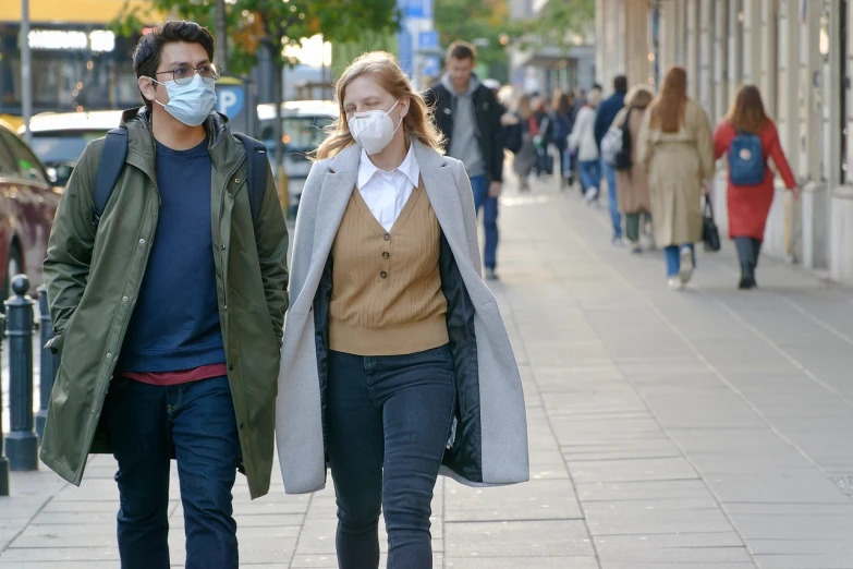 a man and a woman walking down a sidewalk, a picture, by Niko Henrichon, shutterstock, renaissance, air pollution, with a white muzzle, autum, teenage girl