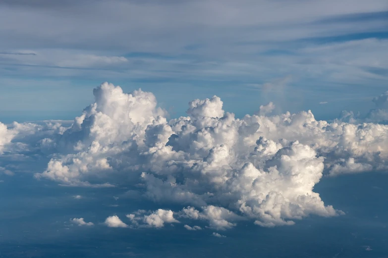 a blue sky filled with lots of white clouds, by Jan Rustem, shutterstock, airborne view, low clouds after rain, thunderclouds, “puffy cloudscape