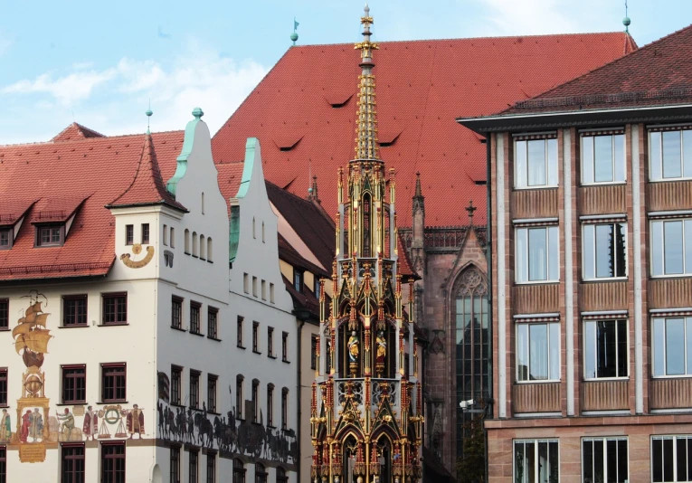 a tall clock tower sitting in the middle of a city, a photo, by Egon von Vietinghoff, intricate copper details, germany, preaching in a fantasy city, red roofs