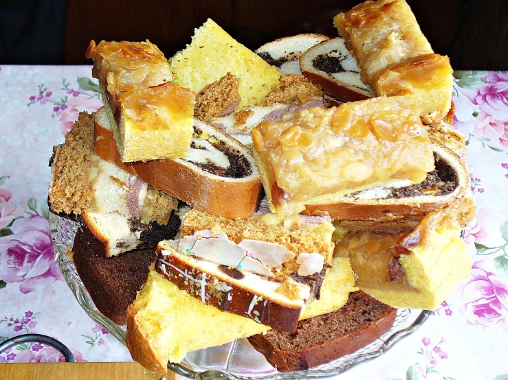 a close up of a plate of food on a table, by Maksimilijan Vanka, flickr, baroque, sliced bread in slots, cakes, piled around, !!award-winning!!