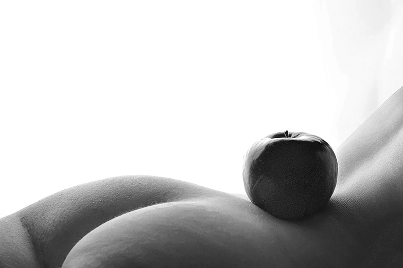 a black and white photo of a naked woman holding an apple, a stock photo, by Leo Leuppi, flickr, minimalism, curvaceous. detailed, lying on an abstract, cutesexyrobutts, natural morning light