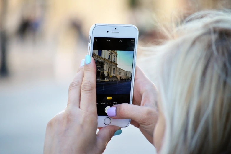 a woman taking a picture with her cell phone, a picture, pexels, realism, instagram post 4k, in city street, modern high sharpness photo, home video footage