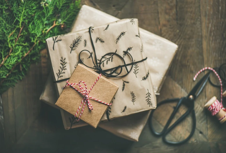 a pile of wrapped presents sitting on top of a wooden table, a portrait, vintage color, top down photo, branches wrapped, closeup photo