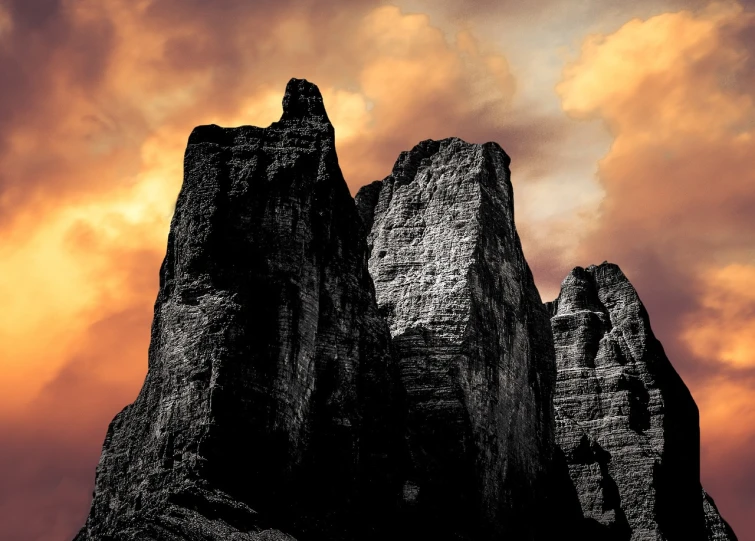 a black and white photo of rocks against a cloudy sky, a matte painting, inspired by Ansel Adams, shutterstock contest winner, romanticism, redscale photography, tall stone spires, in the dolomites, dramatic colors