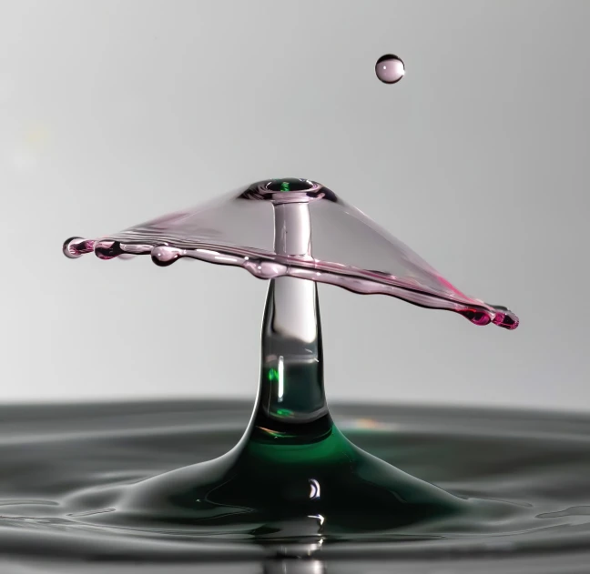 a water drop falling into a body of water, a macro photograph, by Doug Ohlson, unsplash, art photography, purple and green colors, glass sculpture, rising in the air levitating, made of liquid metal and marble