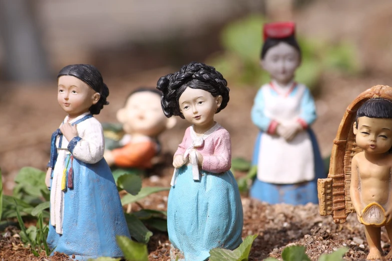 a group of figurines sitting next to each other, a statue, trending on cg society, cloisonnism, korean countryside, closeup photo, gardening, 8 0 mm photo