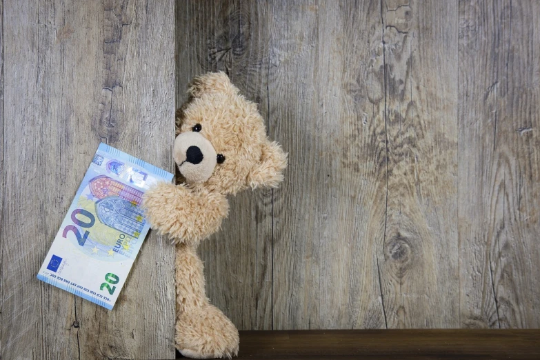 a teddy bear leaning against a wooden wall, a picture, banknote, hiding, sascha schneider, maintenance photo