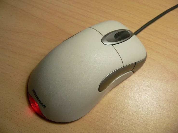 a computer mouse sitting on top of a wooden table, by Robert Medley, flickr, dreamcast, from wikipedia, moonstone, white