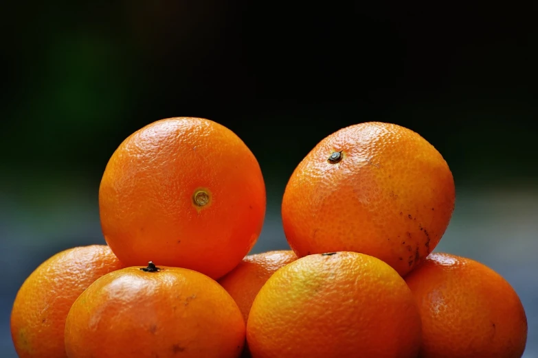 a pile of oranges sitting on top of each other, a picture, by Dietmar Damerau, closeup 4k, dark orange, close-up product photo