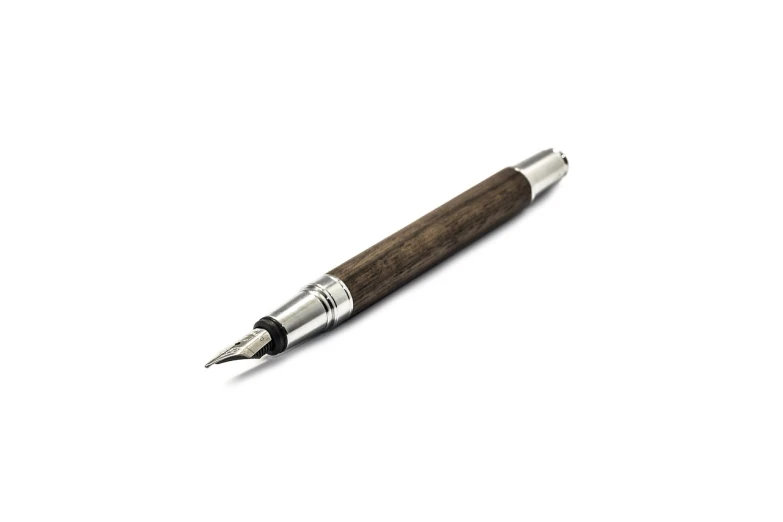 a pen sitting on top of a white surface, by Jakob Gauermann, folk art, dark brown, product photo, silver, walnut wood