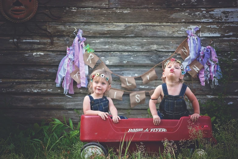 a couple of kids that are sitting in a wagon, by Kristin Nelson, tumblr, red pennants, professionally post-processed, happy birthday, rustic