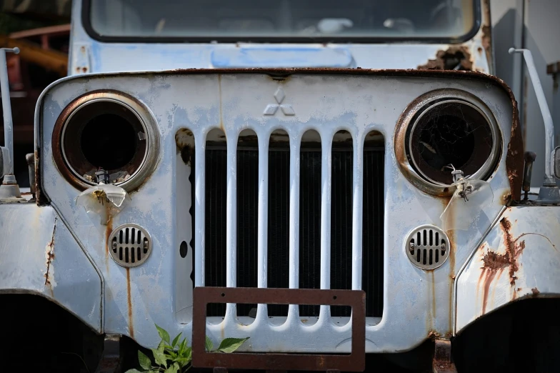 a close up of the front of an old truck, by Richard Carline, auto-destructive art, jeep wrangler, deserted shinjuku junk, marketing photo, with a white muzzle