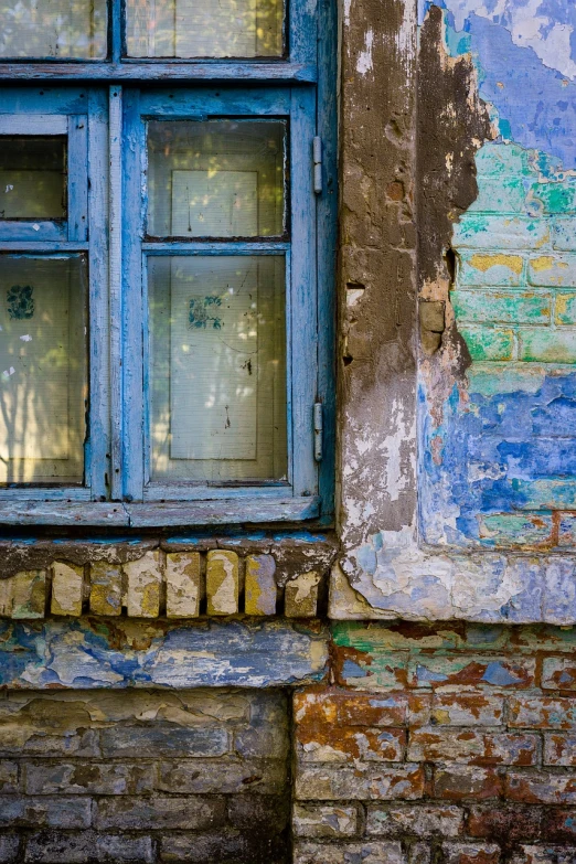 a blue window sitting on the side of a building, a photo, by Svetlin Velinov, colorful mold, brick, sergey zabelin, weathered pages
