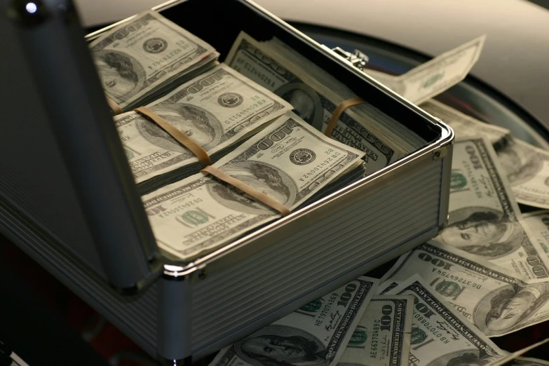 a suitcase full of money sitting on top of a table, a portrait, pixabay, hurufiyya, close up angle, robb cobb, whole bill framed, associated press photo