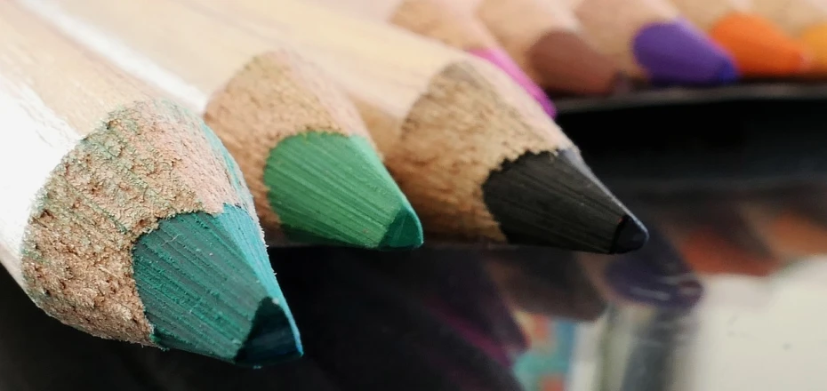 a close up of a group of colored pencils, a macro photograph, by Amelia Peláez, banner, green colours, an artistic pose, colourised