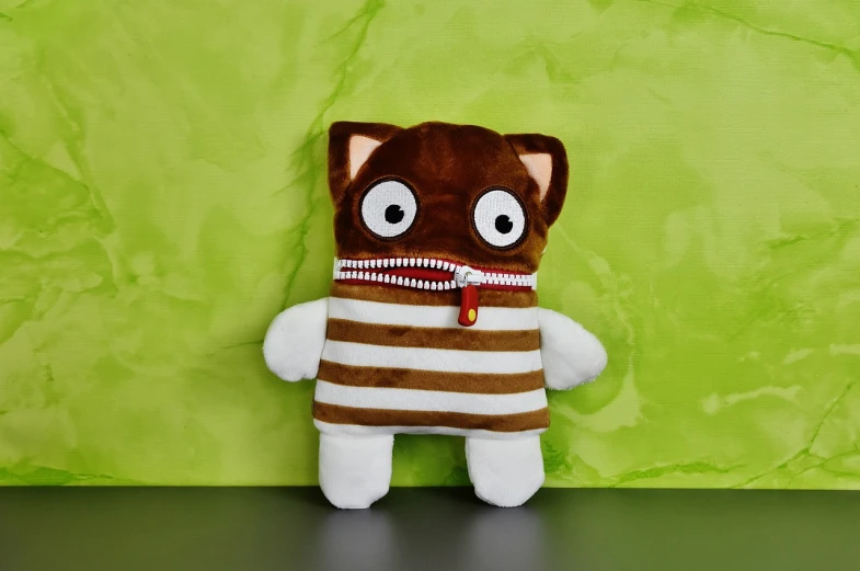 a close up of a stuffed animal on a table, inspired by Muggur, furry art, zippers, hamburglar, pouches, front portrait