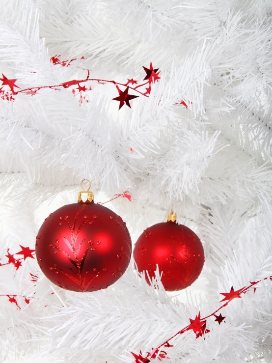 two red ornaments on a white christmas tree, a photo, - h 1 0 2 4, with white, artificial, star