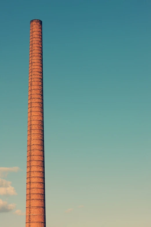 a tall brick chimney sitting in the middle of a field, by Karl Buesgen, postminimalism, industrial factory, in retro colors, portait photo