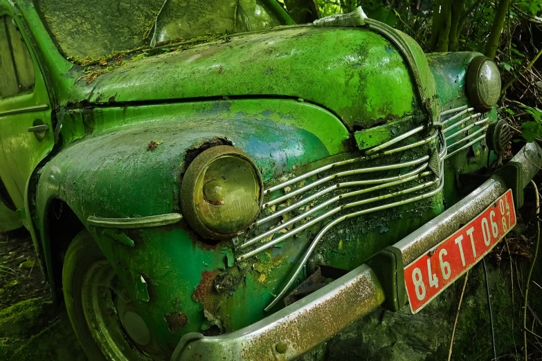 an old green car parked on the side of the road, by Edward Corbett, flickr, dynamic closeup composition, under repairs, forgotten and lost in the forest, hyperdetail