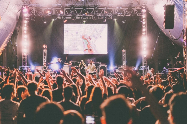 a group of people that are standing in front of a stage, by Dicky Doyle, pexels, happening, live 3hr festival videoclip, 3 5 mm pointing up, led screens, instagram picture