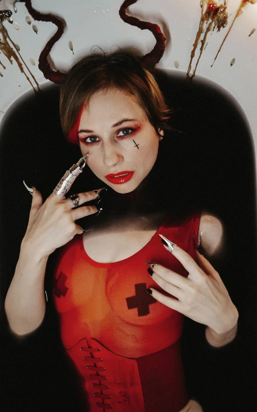 a woman in a red bodysuit holding a pair of scissors, a photo, inspired by Taro Yamamoto, tumblr, gothic art, portrait of harley quinn, medic, y 2 k cutecore clowncore, anna nikonova aka newmilky