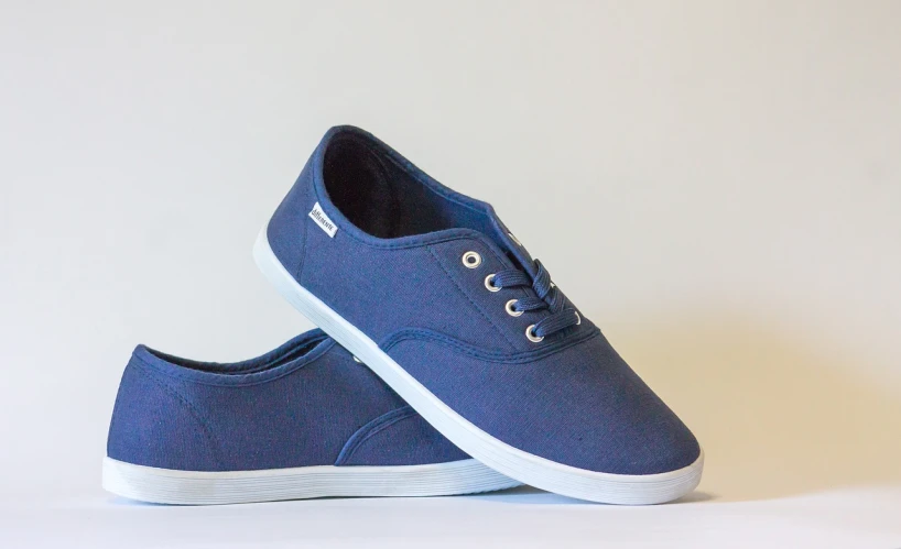 a pair of blue shoes on a white surface, a picture, solid colours material, rhode island, on a gray background, packshot